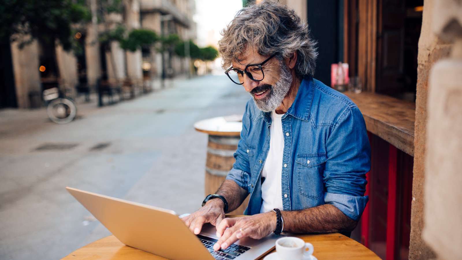 man outside on laptop