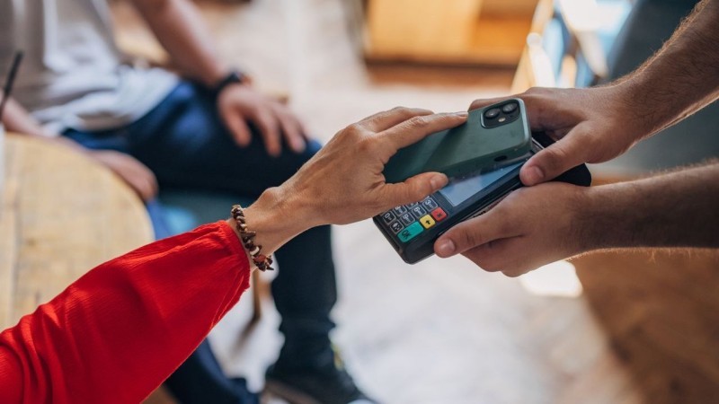 person paying contactless in store